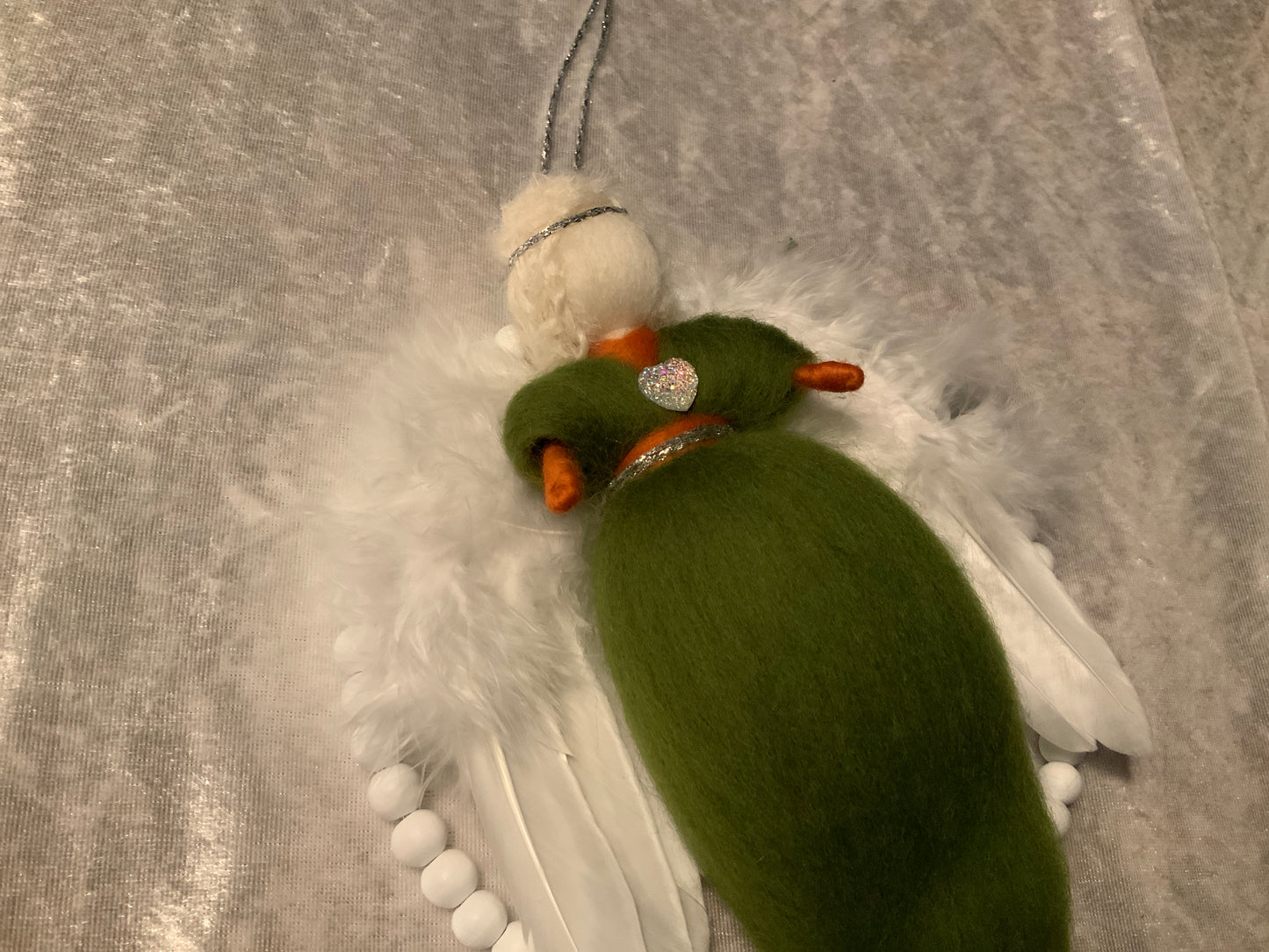 Handgefertigter Engel in einem Holzperlenkreis